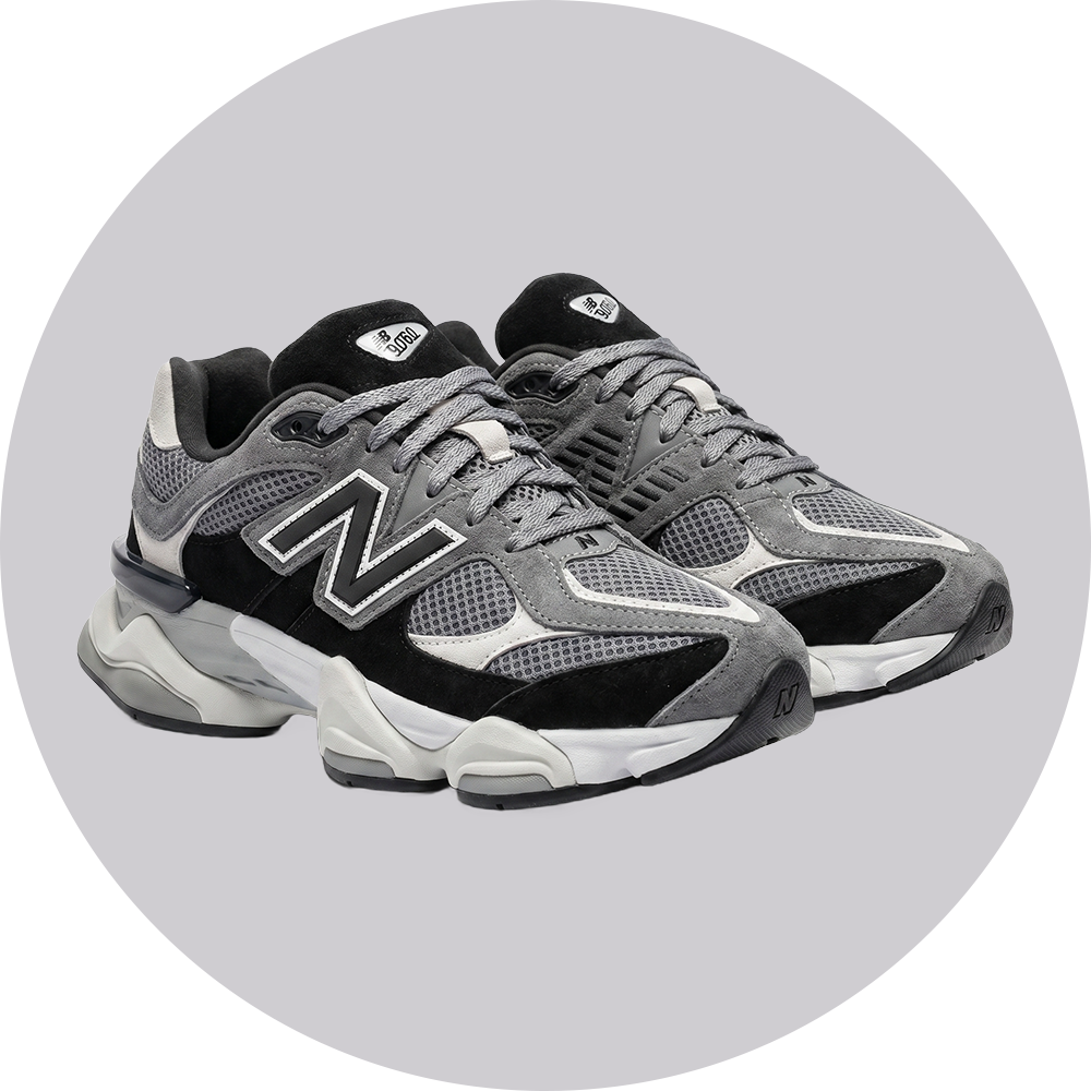 Gray and black New Balance sneakers on a light gray background